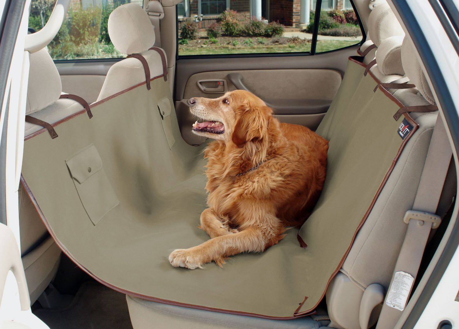 Golden Retriever lying on a cover in the back seat of a car