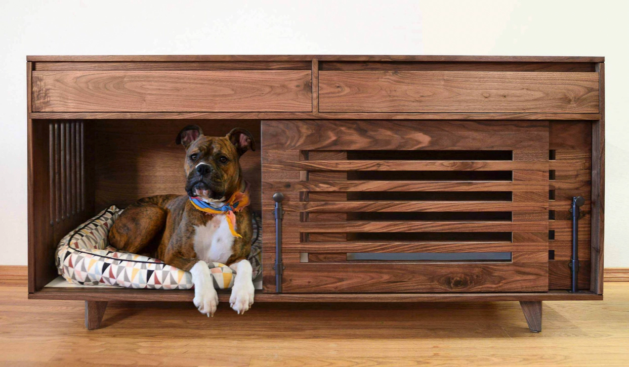 Dog sitting in its portable dog kennel
