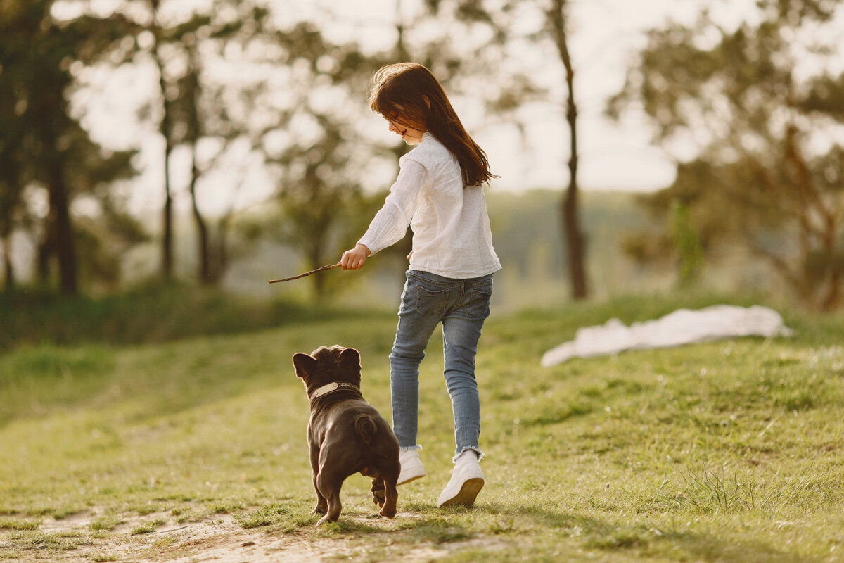 Child and puppy playing outside